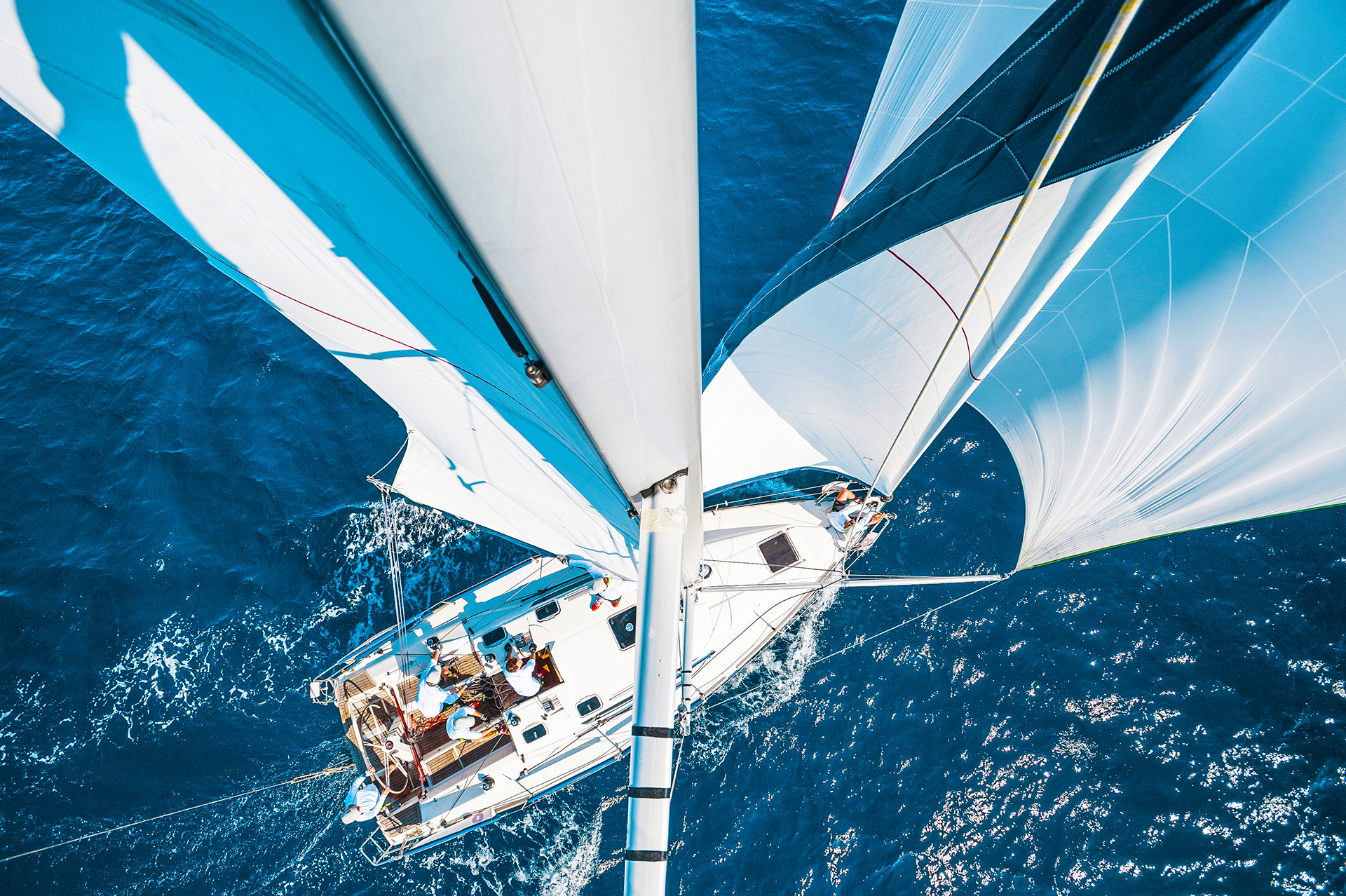 Sailing boat with spinnaker from top of the mast, motion blurred